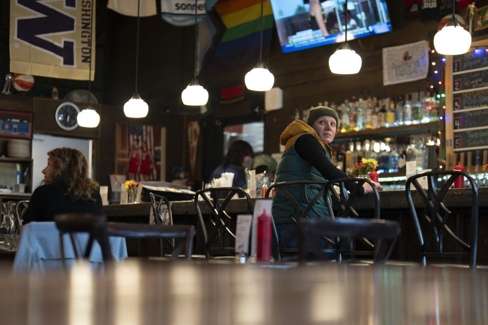 A customer looks at sports memorabilia at The Sports Bra sports bar on Wednesday, April 24, 2024, in Portland, Ore. (AP Photo/Jenny Kane)