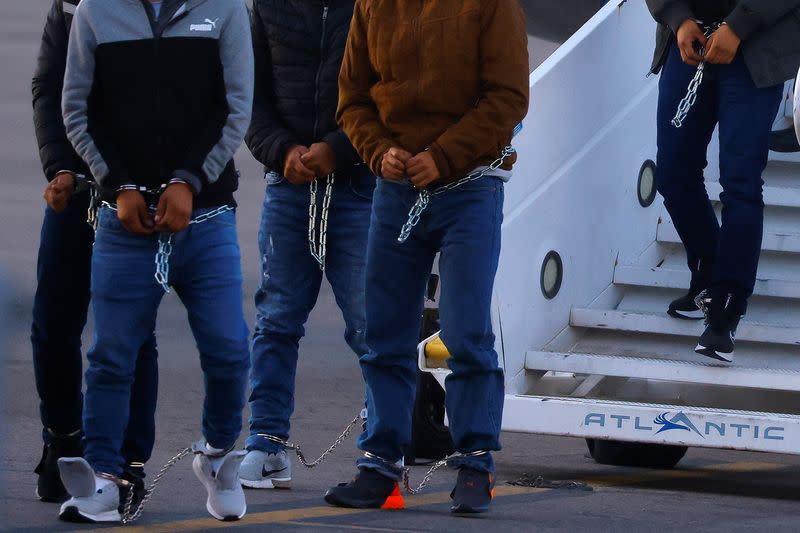 Migrants, transferred from Plattsburgh, New York to El Paso, Texas, disembark from a plane at the airport, in El Paso