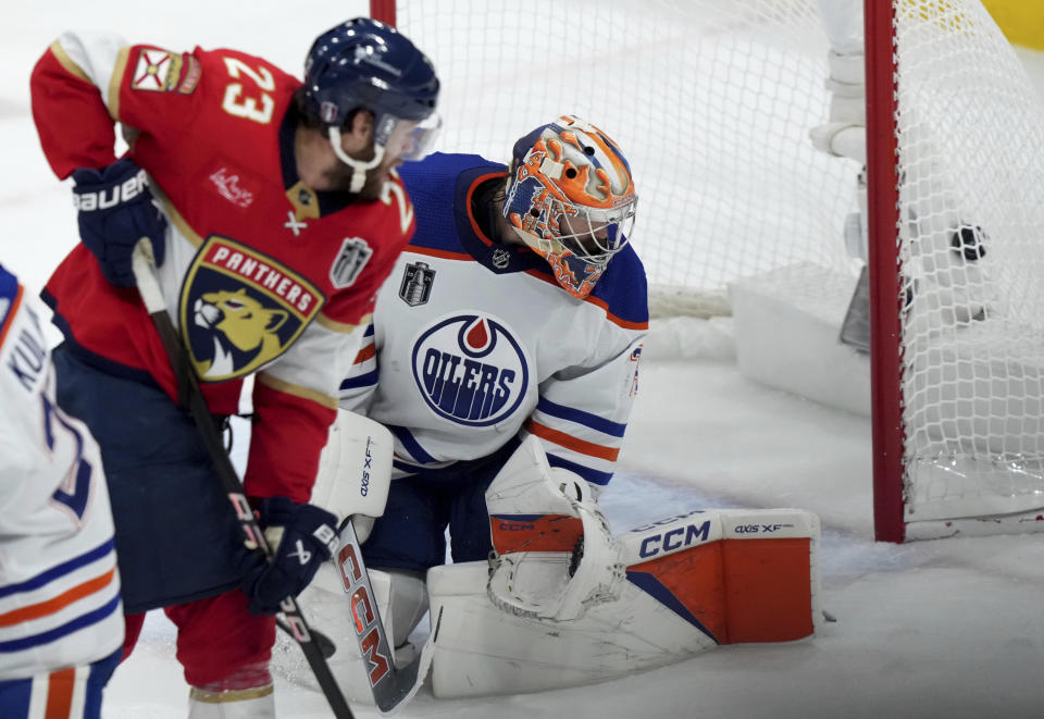 Florida Panthers forward Carter Verhaeghe (23) watches the puck hit the back of the net behind Edmonton Oilers goaltender Stuart Skinner, right, during the second period of Game 7 of the NHL hockey Stanley Cup Final in Sunrise, Fla., Monday, June 24, 2024. (Nathan Denette/The Canadian Press via AP)