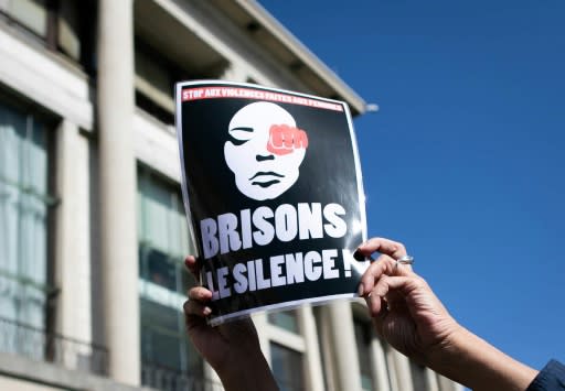 A person holds a sign reading, "Break the silence" during a rally to denounce femicides and domestic violence in Le Havre, northwestern France, in September 2019