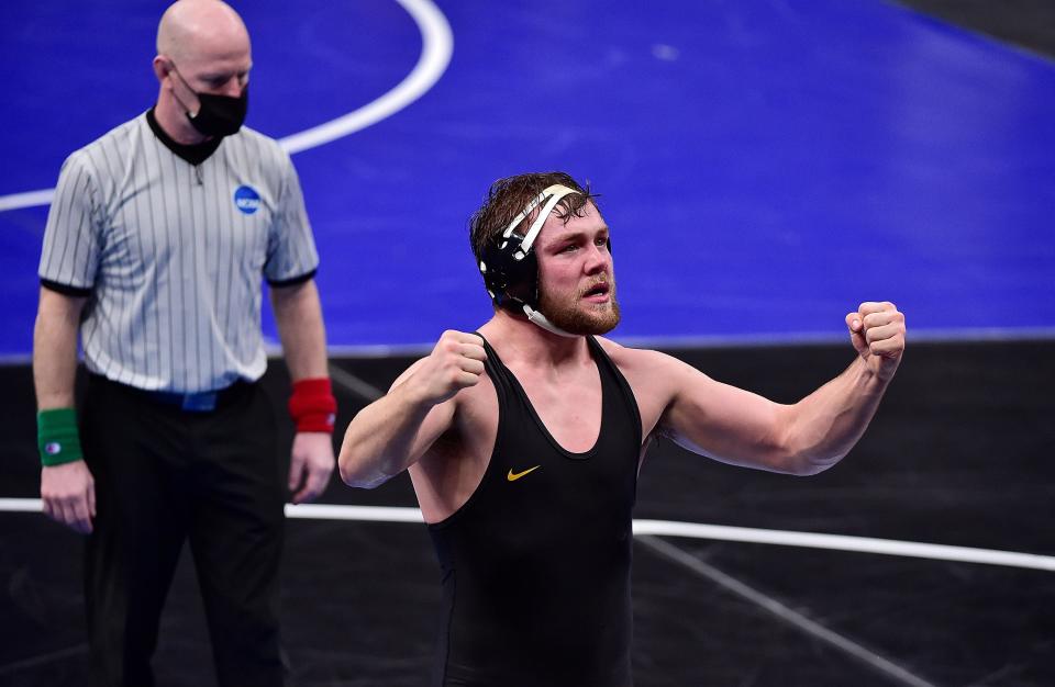 Iowa wrestler Jacob Warner celebrates after defeating N.C. State wrestler Nick Reenan last season.