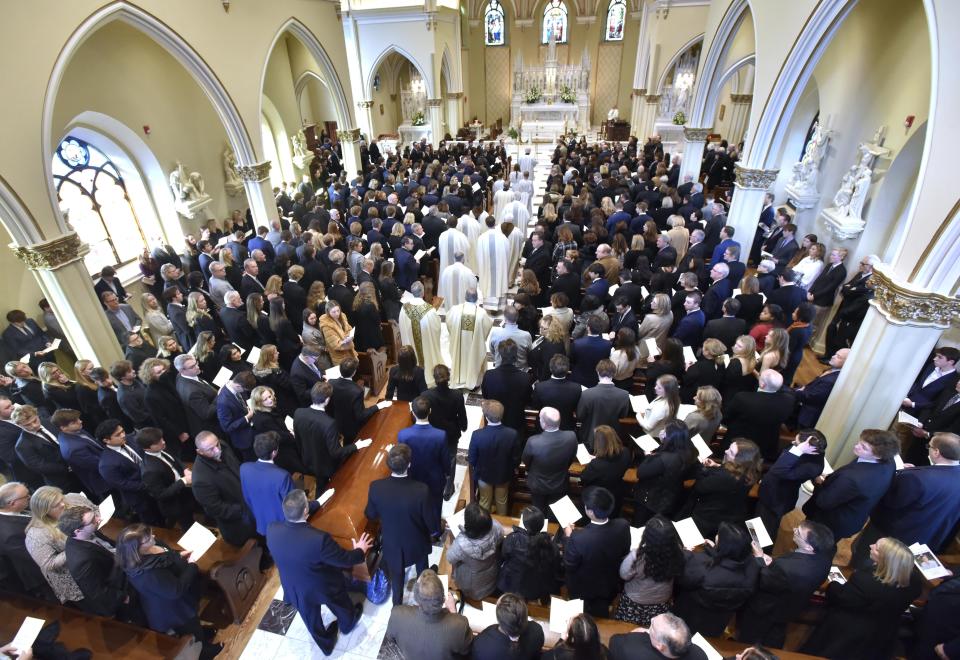 The casket of Brian Fraser proceeds into the church as family members, friends, and supporters gather at the funeral mass for Fraser at St Paul on the Lake Catholic Church, in Grosse Pointe Farms, Mich., Saturday, Feb. 18, 2023. Fraser was identified as one of three students slain during a mass shooting on Michigan State University's campus, Monday evening. (Todd McInturf/Detroit News via AP, Pool)