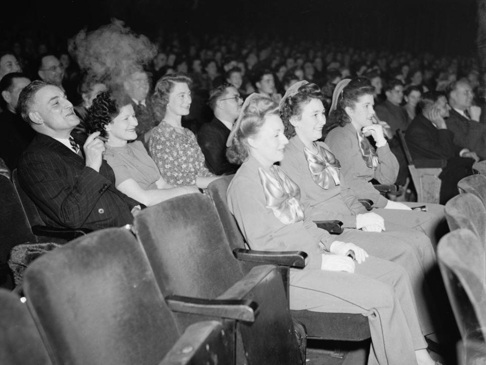 people sitting in a movie theater in 1946