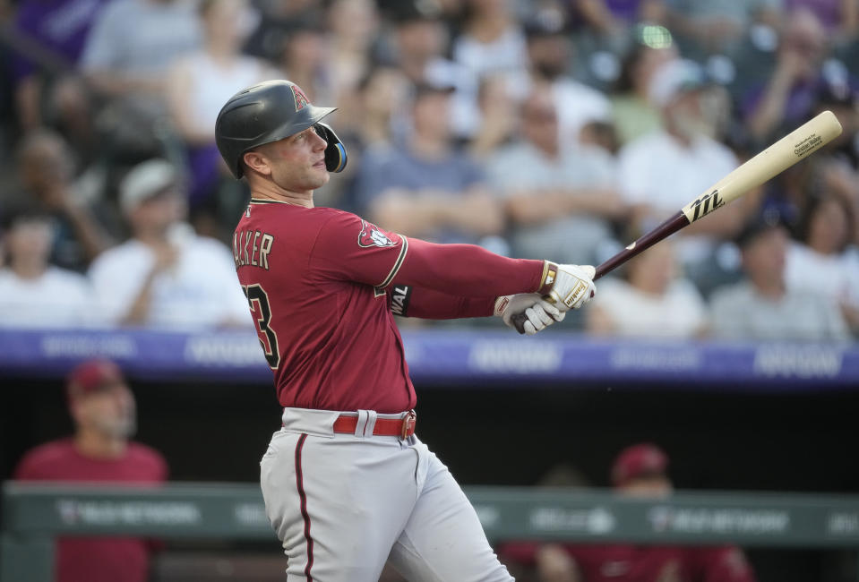 Arizona Diamondbacks' Christian Walker follows the flight of his two-run home run off of Colorado Rockies starting pitcher Ty Blach in the third inning of a baseball game Tuesday, Aug. 15, 2023, in Denver. (AP Photo/David Zalubowski)