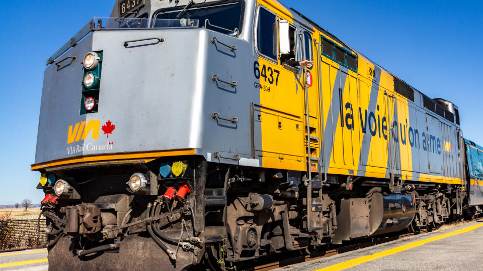 OTTAWA, ONTARIO, CANADA - October 26, 2019: A locomotive engineer waves from a VIA Rail train as it departs Fallowfield Station in Ottawa's Barrahaven neighbourhood.