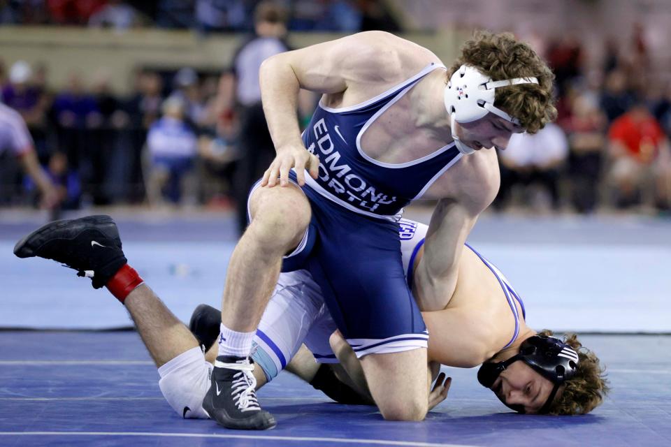Edmond North's Kody Routledge, top, wrestles Stillwater's Landyn Sommer in the Class 6A 157-pound match during the high school state wrestling tournament championships at State Fair Arena in Oklahoma City, Saturday, Feb. 24, 2024.