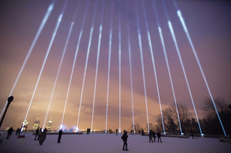 Fourteen lights shine toward the sky during a ceremony on Mount Royal in Montreal to mark the 25th anniversary of the Polytechnique massacre in 2014. Photo from The Canadian Press