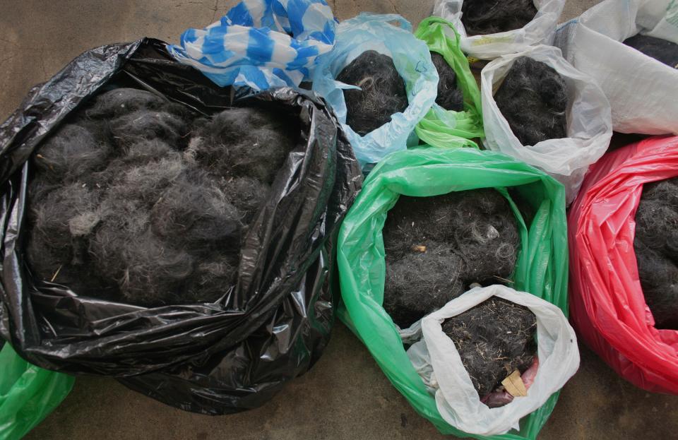 Bags stuffed with inmates' hair to help mop up the oil spill off Guimaras Island, at the National Penitentiary in Muntinlupa, August 31, 2006.<span class="copyright">Paula Bronstein—Getty Images</span>