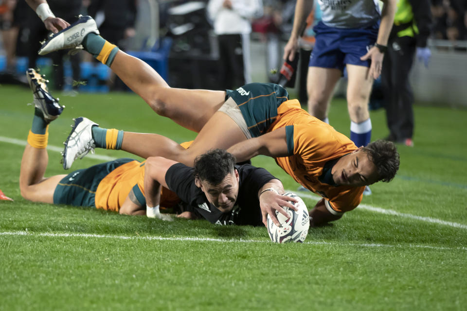 New Zealand's David Havili, left, scores a try against Australia during their Bledisloe Cup rugby union test match at Eden Park in Auckland, New Zealand, Saturday, Aug. 7, 2021. (Brett Phibbs/Photosport via AP)