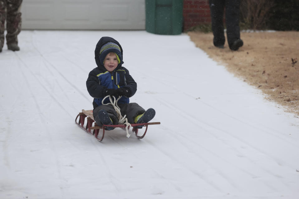 Kemp Foster, 3, learns how to sled in his driveway, Monday, Jan. 15, 2024, in Tupelo, Miss. (Thomas Wells/The Northeast Mississippi Daily Journal via AP)