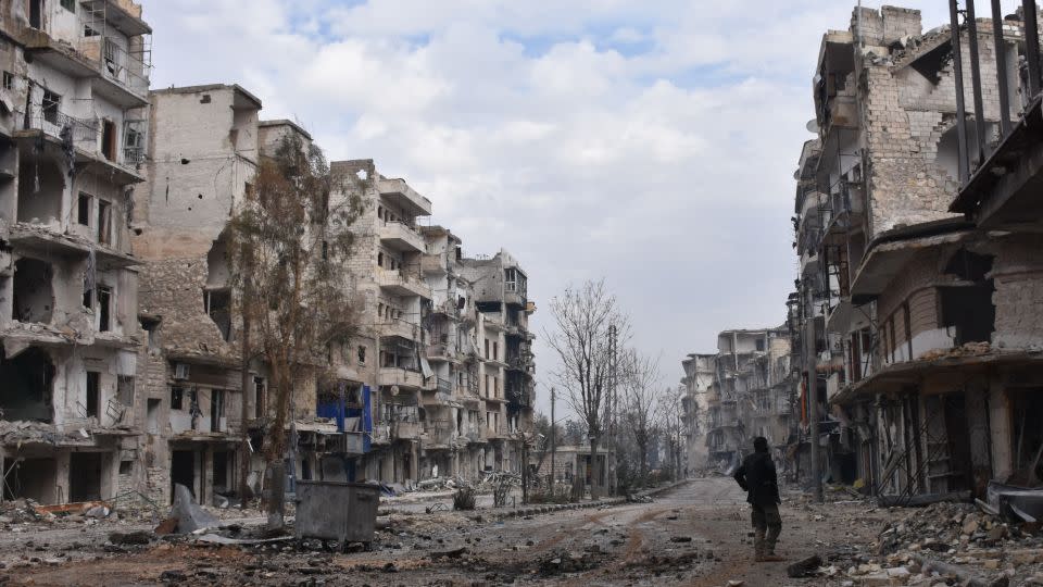 A member of the Syrian regime forces stands amidst destruction in the former rebel-held Sukkari district in Aleppo on December 23, 2016. The city was one of the hardest-hit areas of the civil war.  - George Ourfalian/AFP/Getty Images