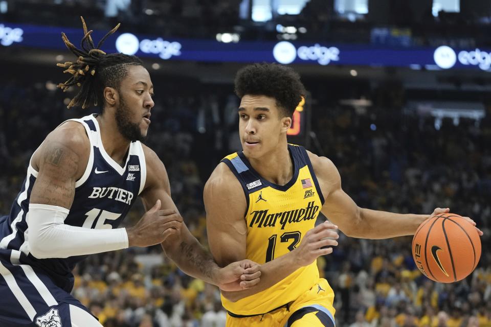 Marquette's Oso Ighodaro tries to drive past Butler's Manny Bates during the first half of an NCAA college basketball game Saturday, Feb. 4, 2023, in Milwaukee. (AP Photo/Morry Gash)