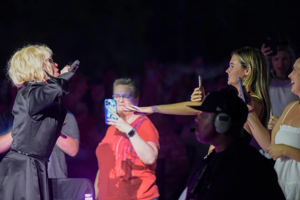 At the beginning of her show, Shania Twain appears in the middle of the ground and interacts with fans before continuing the show on stage at PNC Music Pavilion on Wednesday, June 28, 2023.