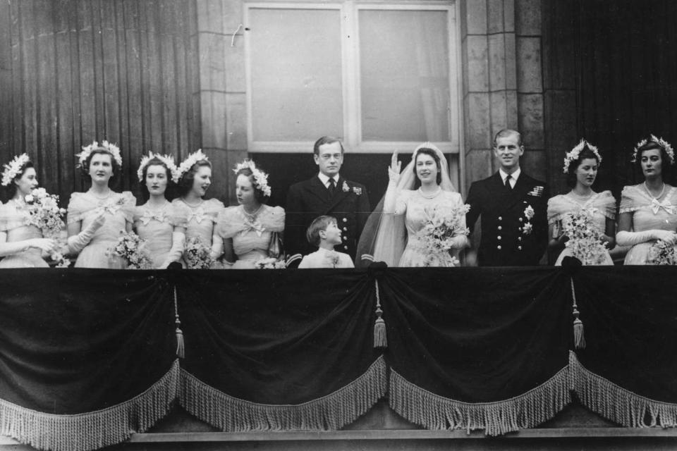 <p>Topical Press Agency/Getty</p> (From left) Princess Margaret, Margaret Elphinstone, Diana Bowes-Lyon, Lady Caroline Montague Douglas-Scott, Lady Elizabeth Lambert, the Marquis of Milford-Haven, Prince William, Queen Elizabeth, Prince Philip, Lady Mary Cambridge and Lady Pamela Mountbatten on the future Queen Elizabeth and Prince Philip