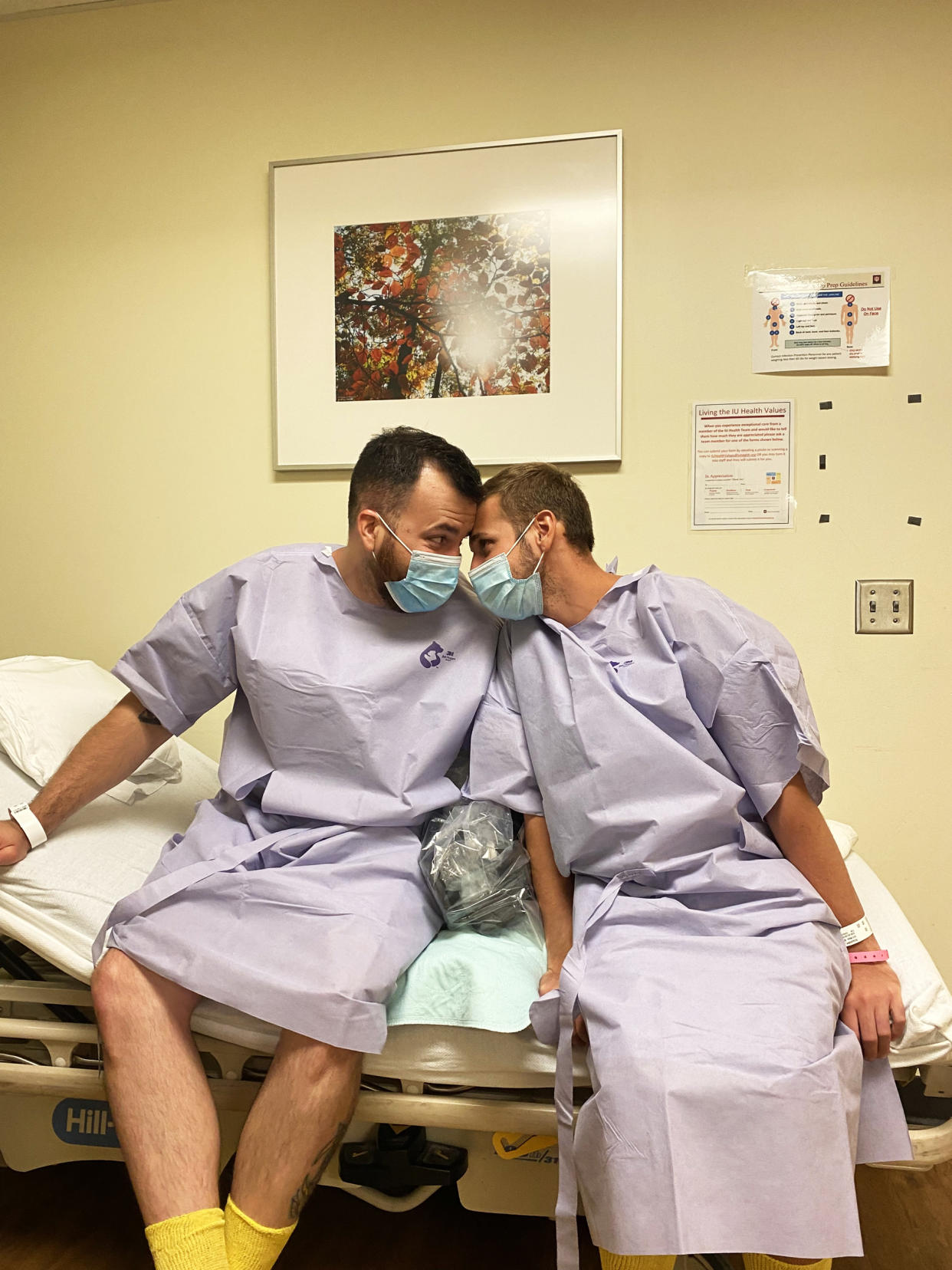 Husbands Rafael Diaz, left, and Reid Alexander share a tender moment together at Indiana University Health Methodist Hospital in Indianapolis on Aug. 13, 2021. Diaz donated one of his kidneys to Alexander. (Courtesy Rafael Diaz)