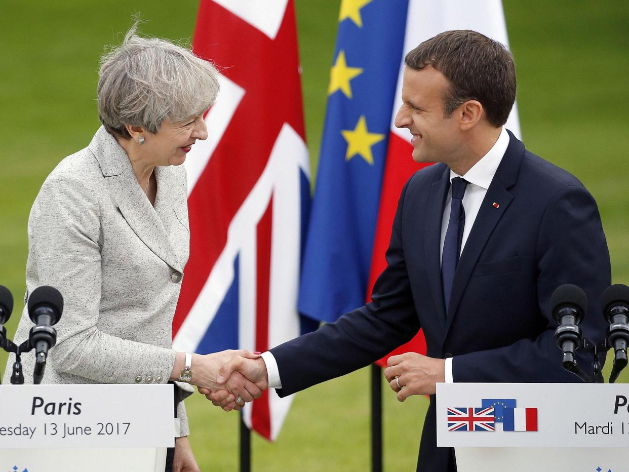 French President Emmanuel Macron shakes hands with Theresa May after a joint press conference at the Elysee Presidential Palace on 13 June: Getty Images