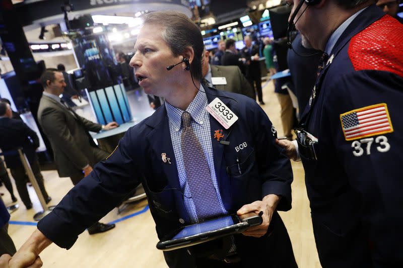 Traders work on the floor of the New York Stock Exchange (NYSE) shortly after the opening bell in New York, U.S., January 13, 2017. REUTERS/Lucas Jackson