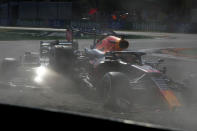 Red Bull driver Max Verstappen of the Netherlands, right and Mercedes driver Lewis Hamilton of Britain crash during the Italian Formula One Grand Prix, at Monza racetrack, in Monza, Italy, Sunday, Sept.12, 2021. (AP Photo/Luca Bruno)