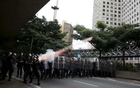 Riot police fire tear gas at demonstrators during a protest against fare hikes for city buses in Sao Paulo, Brazil, January 8, 2016. REUTERS/Nacho Doce