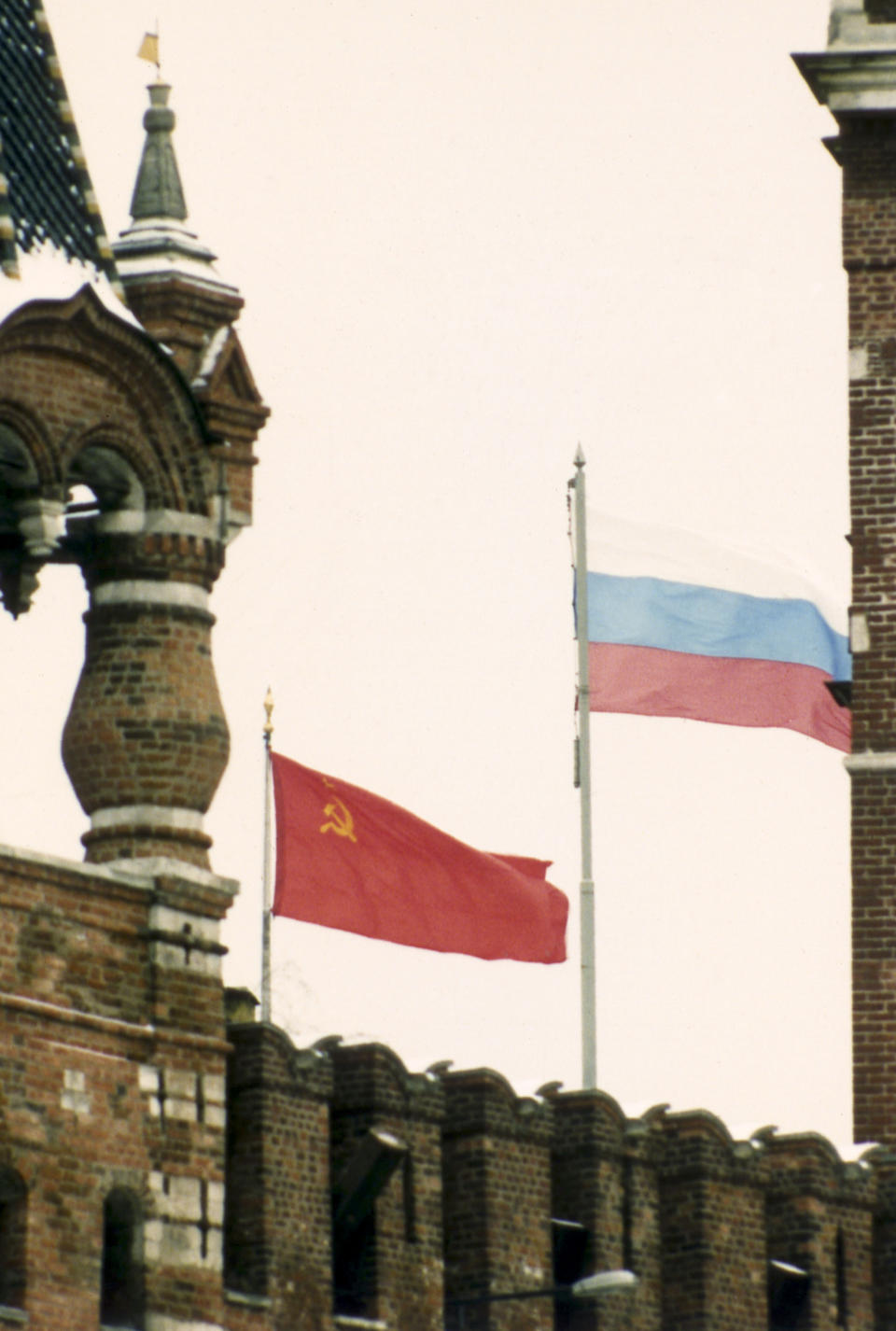 FILE - The flag of the Soviet Union, left, and the flag of the Russian Republic fly side by side over the Kremlin in Moscow, on Saturday, Dec. 21, 1991. After Soviet President Mikhail Gorbachev stepped down on Dec. 25, 1991, people strolling across Moscow's snowy Red Square on the evening of Dec. 25 were surprised to witness one of the 20th century’s most pivotal moments — the Soviet red flag over the Kremlin pulled down and replaced with the Russian Federation's tricolor. (AP Photo/Alexander Zemlianichenko, File)