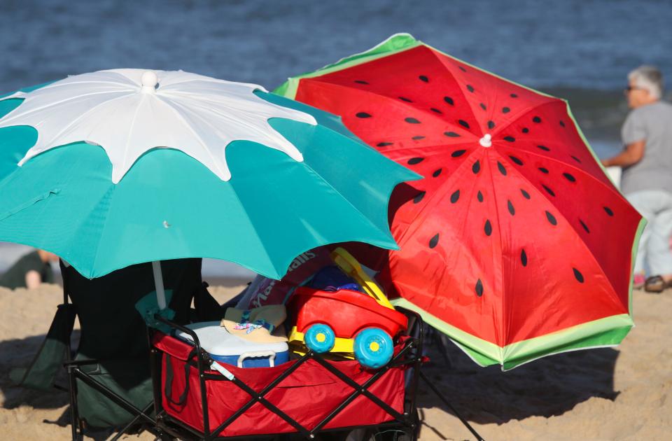 Colorful umbrellas ward off the sun on a cloudless late afternoon at Cape Henlopen State Park, Saturday, Sept. 2, 2023 during the unofficial end to summer, Labor Day Weekend.