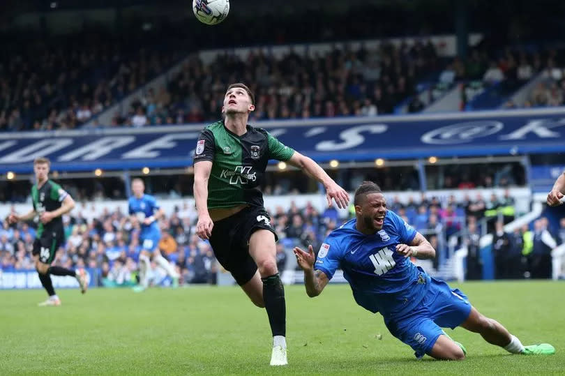 Birmingham City's Tyler Roberts (right) and Coventry City's Bobby Thomas battle for the ball