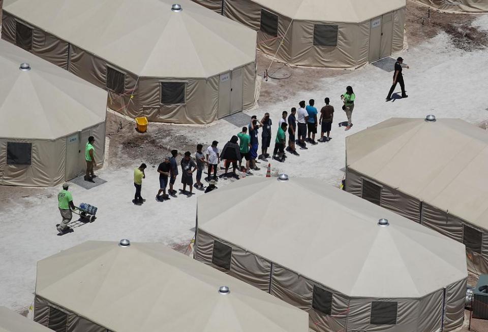 Children and workers are seen at a tent encampment near the Tornillo port of entry on 19 June 2018 in Tornillo, Texas