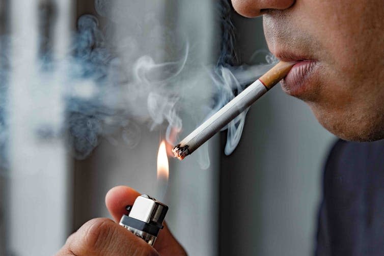 <span class="caption">Unhealthy behaviours, such as smoking and drinking, cluster together.</span> <span class="attribution"><a class="link " href="https://www.shutterstock.com/image-photo/close-young-man-smoking-cigarette-1106869442" rel="nofollow noopener" target="_blank" data-ylk="slk:Nopphon_1987/ Shutterstock;elm:context_link;itc:0;sec:content-canvas">Nopphon_1987/ Shutterstock</a></span>