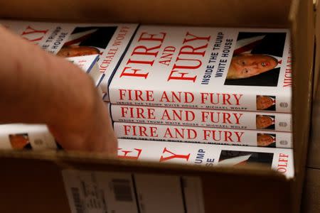 An employee of Book Culture book store unloads copies of "Fire and Fury: Inside the Trump White House" by author Michael Wolff inside the store in New York, U.S. January 5, 2018. REUTERS/Shannon Stapleton