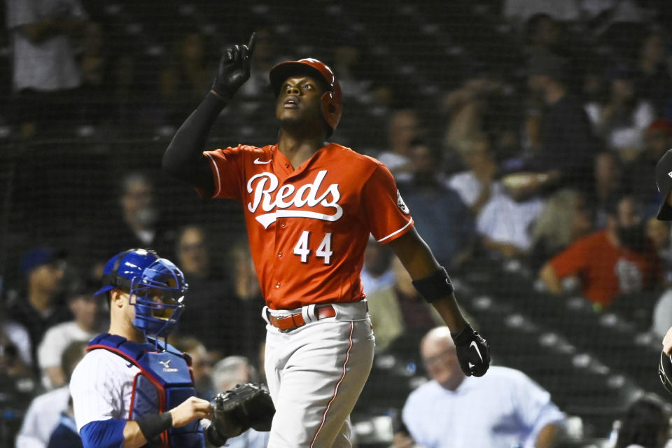 Cincinnati Reds' Aristides Aquino points to the sky after he hit a home run against the Chicago Cubs during the ninth inning of a baseball game, Wednesday, Sept. 7, 2022, in Chicago. (AP Photo/Matt Marton)