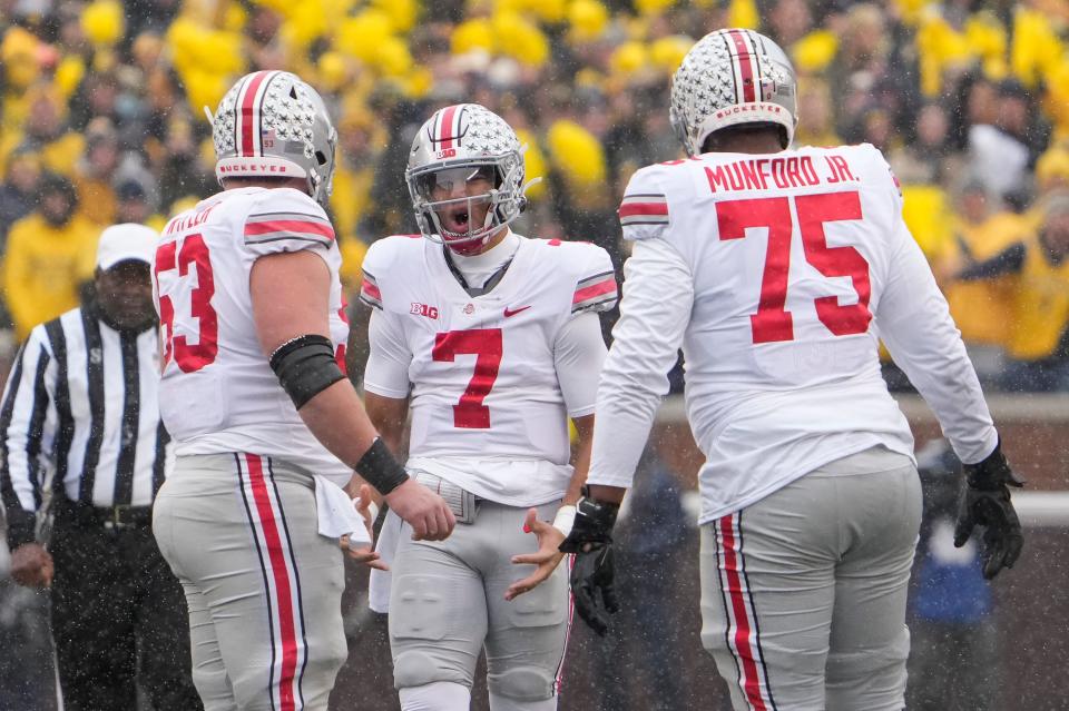 Ohio State Buckeyes quarterback C.J. Stroud (7) complains about a false start with offensive lineman Luke Wypler (53) and offensive lineman Thayer Munford (75) during the second quarter of the NCAA football game at Michigan Stadium in Ann Arbor on Saturday, Nov. 27, 2021.