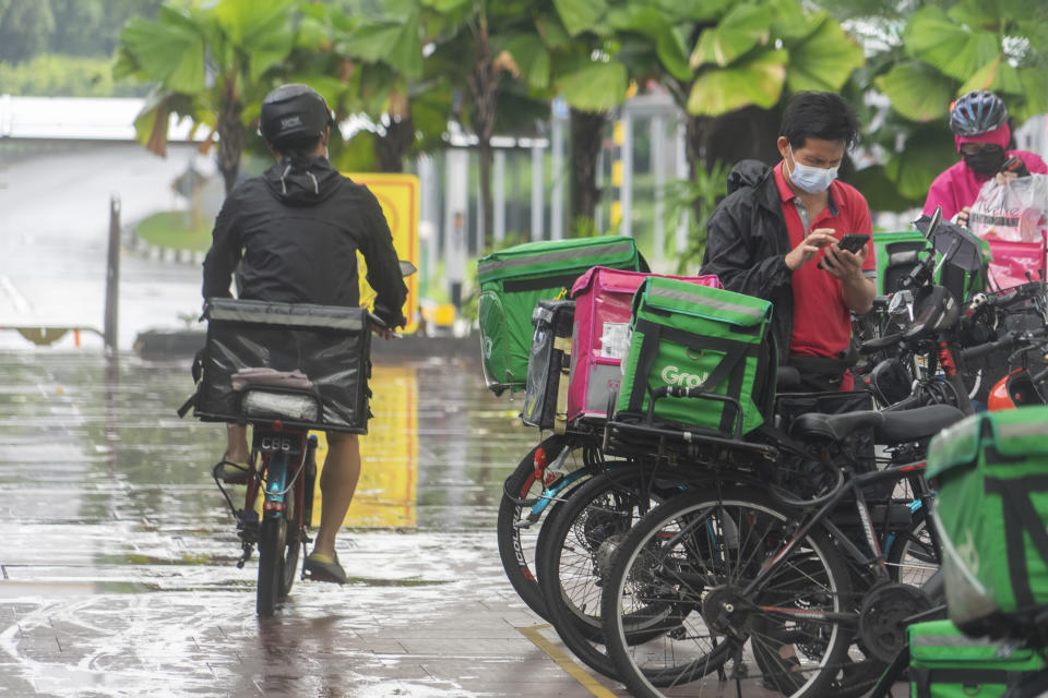 Drivers for Singapore’s food delivery and ride-hailing companies are often working almost 60 hours a week, a survey found. (PHOTO: Getty Creative)