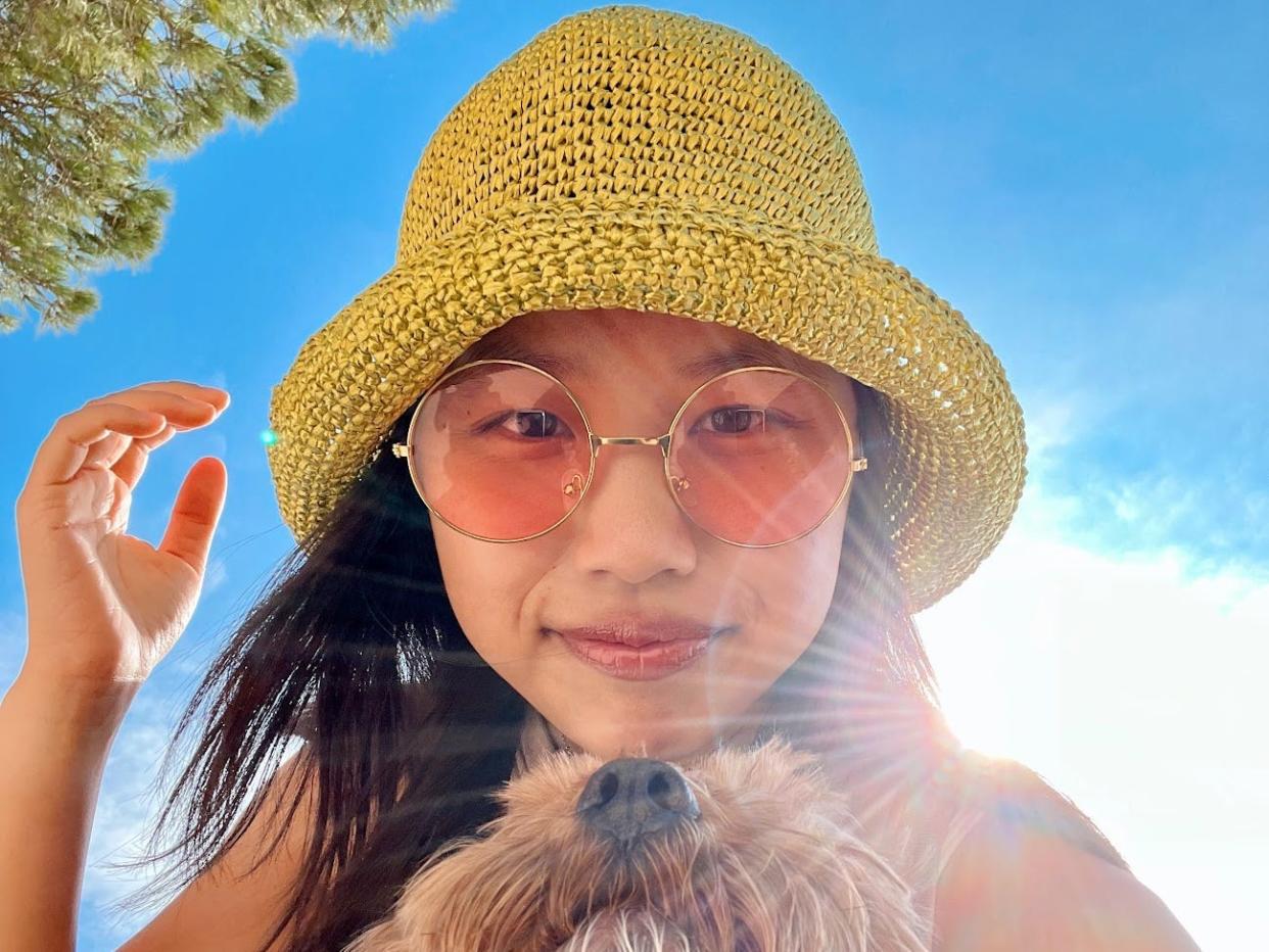 Tiffany Zhong TZ wears hat in sun pink sunglasses