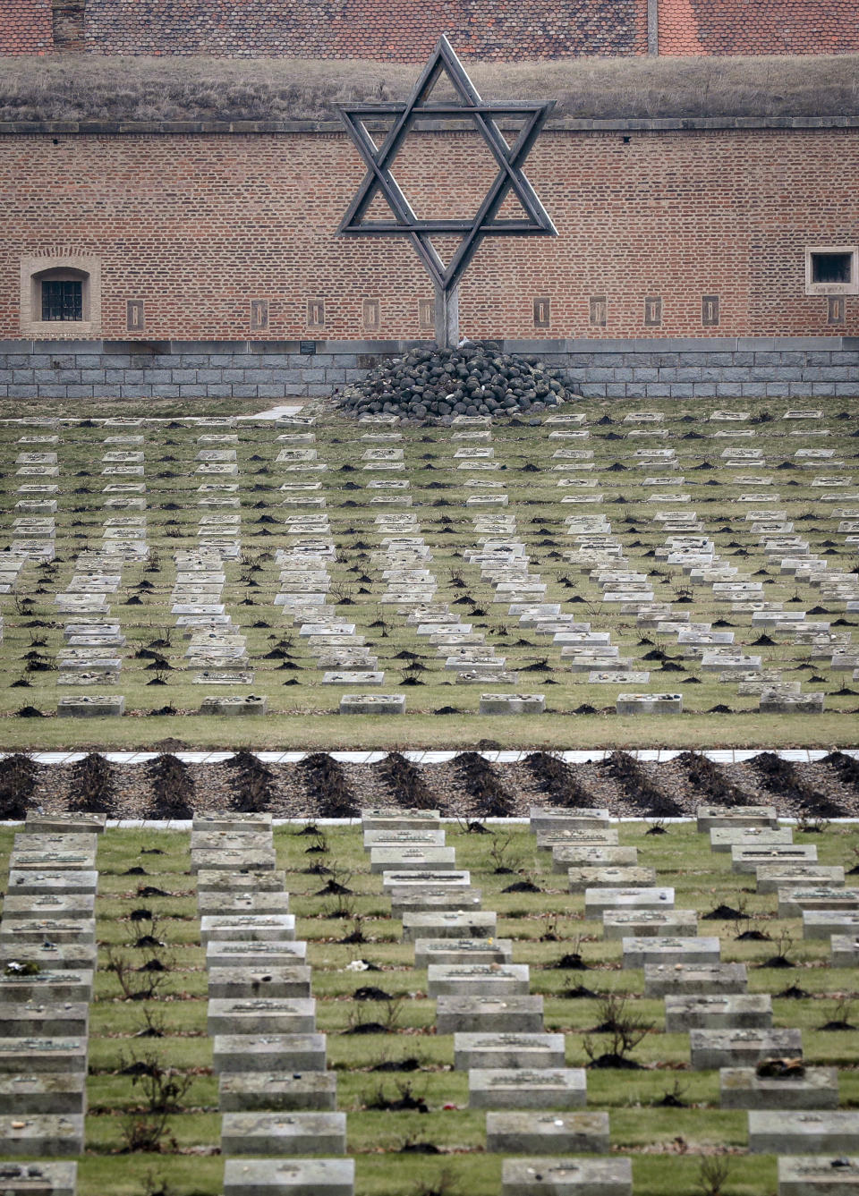 The cemetery of the former Nazi concentration camp in Terezin, Czech Republic, Thursday, Jan. 24, 2019. A unique collection of some 4,500 drawings by children who were interned at the Theresienstadt concentration camp during the Holocaust now displayed in the Pinkas Synagogue, still attracts attention even after 75 years since their creation. The drawings depict the everyday life as well hopes and dreams of returning home. (AP Photo/Petr David Josek)