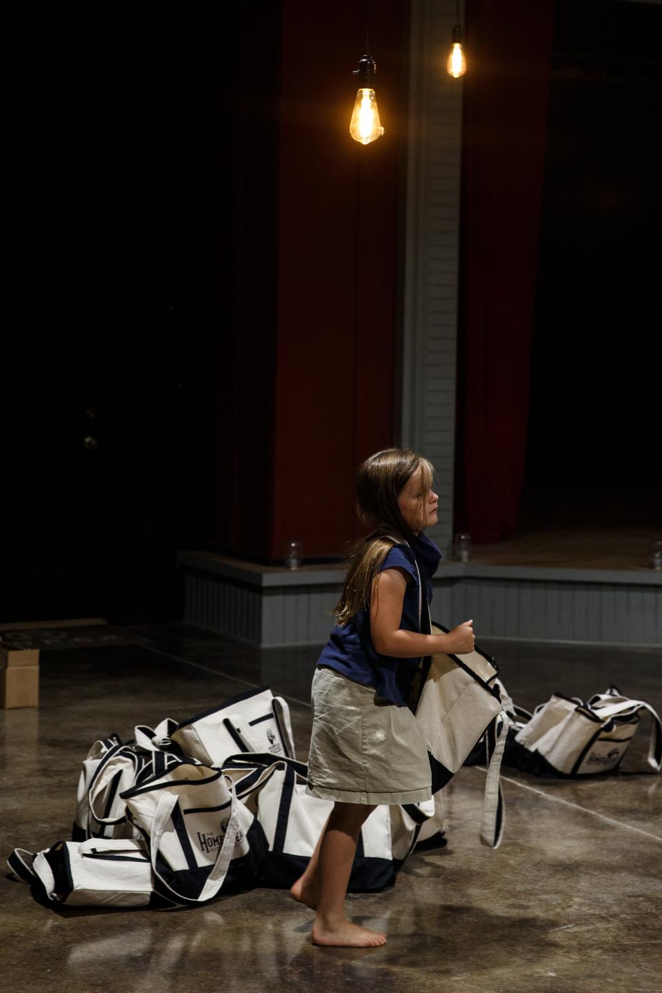 A child from the Homestead School packs bags in preparation for the Homestead Festival in Columbia, Tenn. on May 31, 2023