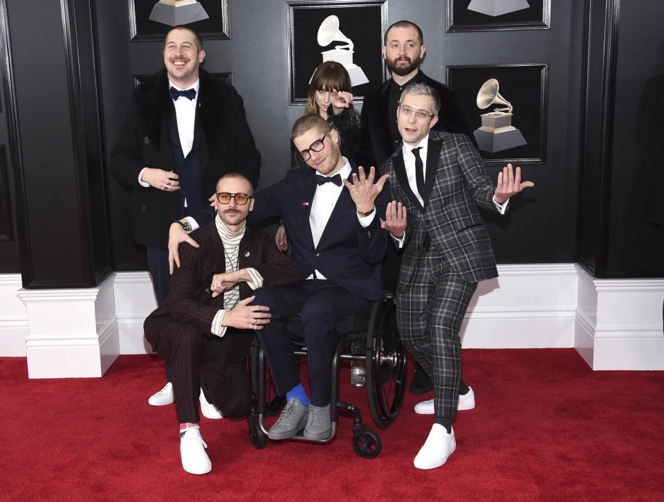 FILE - In this Jan. 28, 2018 file photo, from left, Zachary Scott Carothers, John Gourley, Eric Howk, Zoe Manville, Jason Wade Sechrist and Kyle O'Quin of Portugal. The Man arrive at the 60th annual Grammy Awards at Madison Square Garden in New York. The state of Alaska's new hold music is on hold. A project to replace the sleepy hold music for state office lines with music by Alaska artists drew widespread attention when it was announced in November, touting Portugal. The Man and four other artists with Alaska ties. A spokesman for Gov. Mike Dunleavy says it was muted shortly thereafter after concerns with some of the music were raised by the public.(Photo by Evan Agostini/Invision/AP, File)