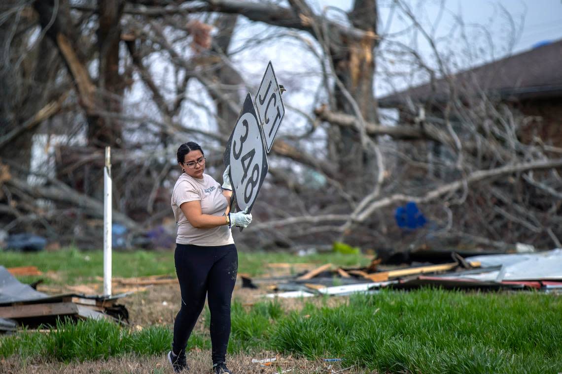 Aileen Guillermo, a student at Trinity Christian College in Illinois, helps clean up near Fremont, Ky., on Monday, March 6, 2023, following a tornado that struck the community in McCracken County three days prior.