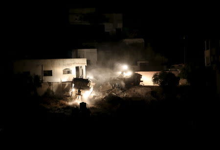 Israeli army bulldozers demolish a Palestinian house during an Israeli raid in the West Bank city of Jenin September 1, 2015. REUTERS/Mohamad Torokman