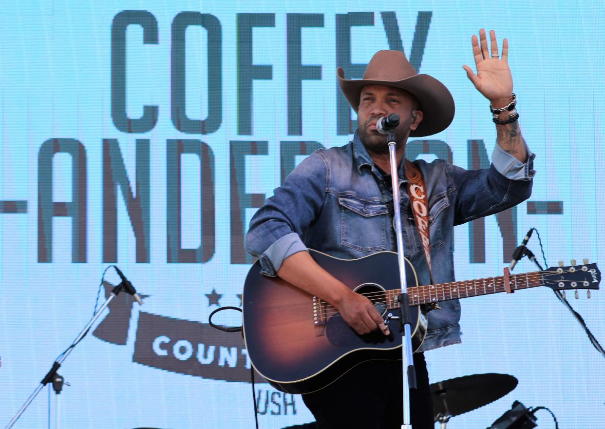 Country singer Coffey Anderson, who grew in Bangs, waves to fans at the start of his parking lot concert March 24 in Tuscola. Anderson is back in Texas and touring new Allsup's convenience store locations. He is scheduled to be in Abilene on Saturday evening.