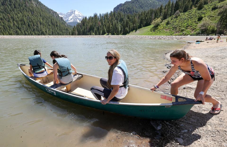 From right, Kaylee Harding gives Lori Lowe, Lilly Betenson and Sophia Rosenlof a push as they canoe on Tibble Fork Reservoir in American Fork Canyon on Tuesday, May 30, 2023. | Kristin Murphy, Deseret News