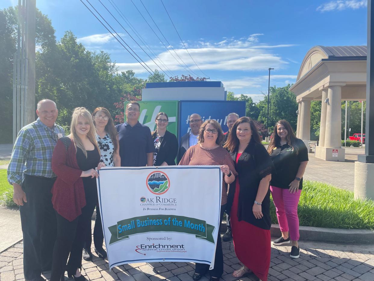 Representatives from the Oak Ridge Chamber of Commerce and Enrichment Federal Credit Union presented the Holiday Inn Express and Suites a banner to recognize the hotel’s selection as the Chamber’s Small Business of the Month for June. Pictured are: Norm Nelson, Brittany Hensley, Chris Hicks, Cindy Adkins, Heather Brown, Joe Valentino, April Fugate, Chip Dooley, Kelley O’Dell and Jennifer Wilson.