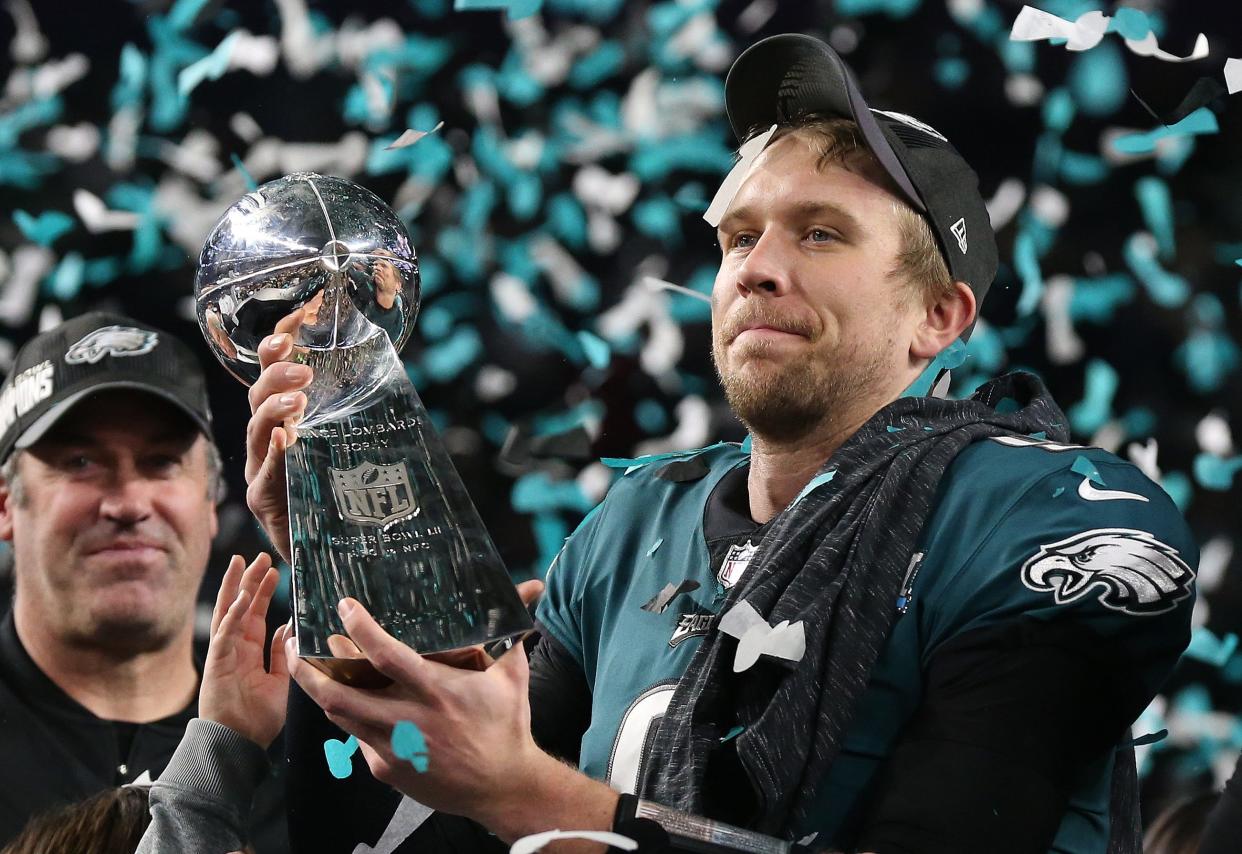 Philadelphia Eagles quarterback Nick Foles (9) hoist the Vince Lombardi Trophy after a victory against the New England Patriots in Super Bowl LII at U.S. Bank Stadium.