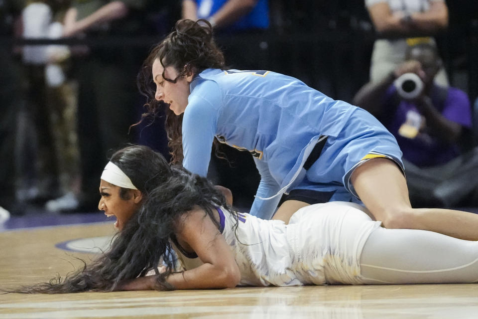 LSU forward Angel Reese reacts after battling for a loose ball against Kent State guard Katie Shumate, above, in the first half an NCAA college basketball game in Baton Rouge, La., Tuesday, Nov. 14, 2023. (AP Photo/Gerald Herbert)