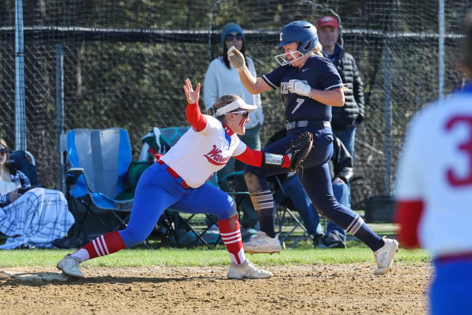 Winnacunnet first baseman Jocelyn Snow stretches to catch the ball ahead of Exeter's Kristin Bickford during Friday's Division I softball game.