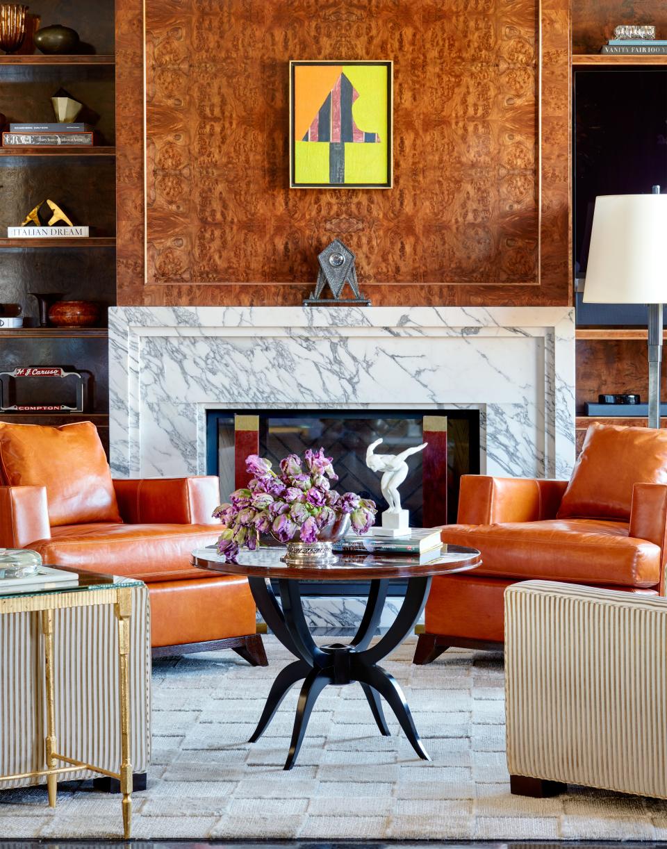 Burl-wood paneling wraps the lounge. Hand-knotted banana silk rug by Marc Phillips rugs.