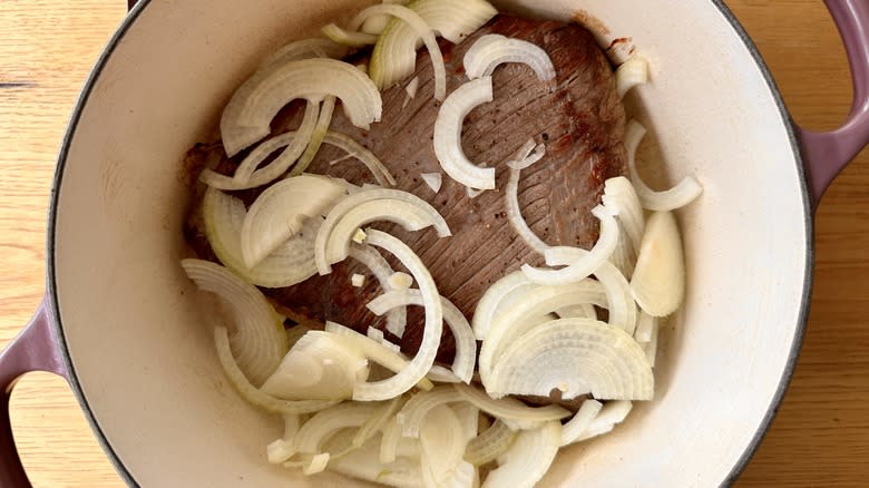 sliced onions and seared brisket