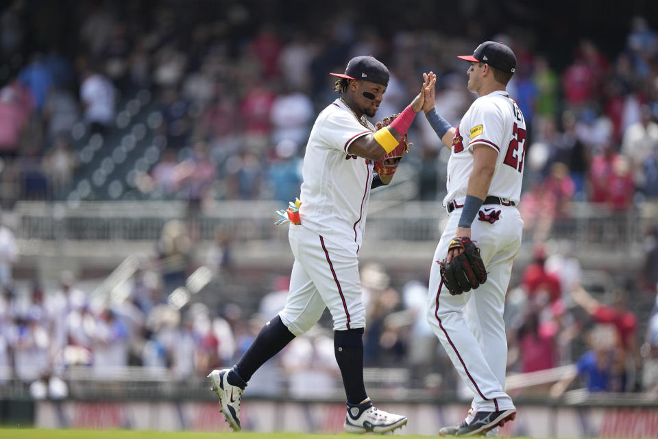 Atlanta Braves' Ronald Acuna Jr., left, celebrates with Austin Riley, right, after a win against the Los Angeles Angels, Wednesday, Aug. 2, 2023, in Atlanta. (AP Photo/Brynn Anderson)