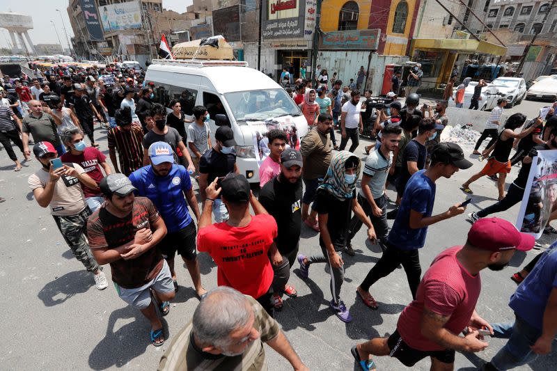 Iraqi demonstrators attend the funeral of a protester, who was killed last night during the ongoing anti-government protest due to poor public services at Tahrir Square in Baghdad