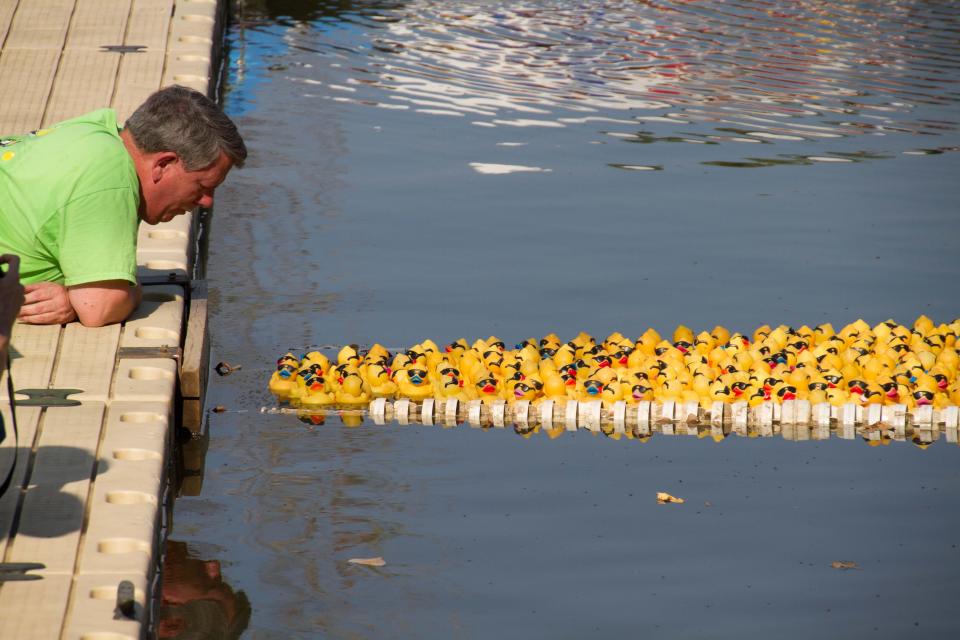 A Sertoma volunteer waits as ducks near the finish line during the Sertoma Great Topeka Duck Race. Each duck will cost $5, and gets you a chance to win one of several prizes. Proceeds benefit Sertoma beneficiaries in Topeka.