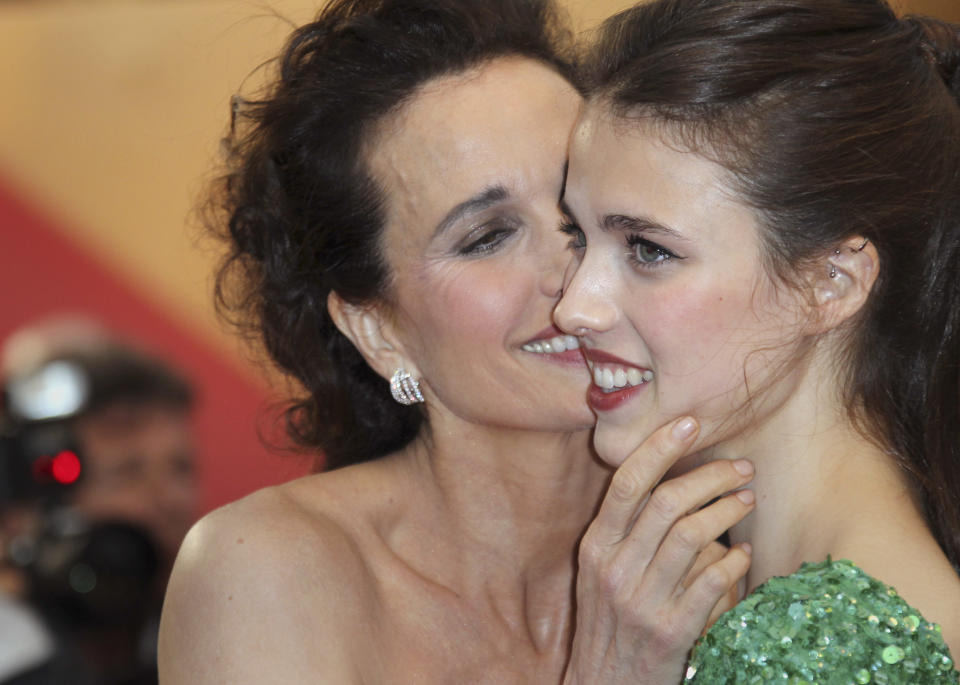 Actress Andie MacDowell, left, holds the face of her daughter Sarah Qualley as they arrive for the awards ceremony at the 65th international film festival, in Cannes, southern France, Sunday, May 27, 2012. (AP Photo/Joel Ryan)